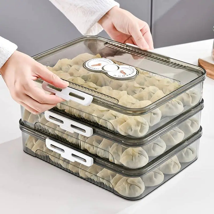 Stackable clear containers with dumplings inside on a light gray background